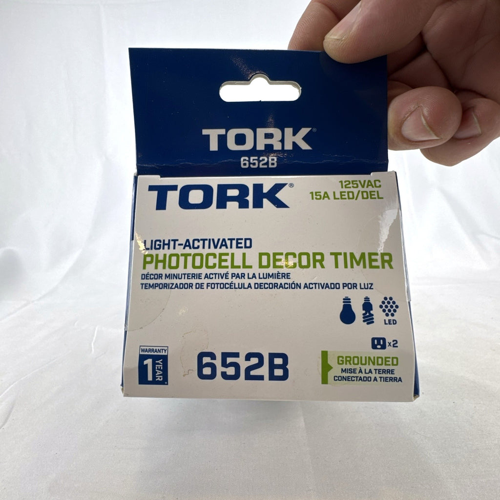 TORK 652B black outdoor photocell light timer with dual grounded outlets in its original packaging.