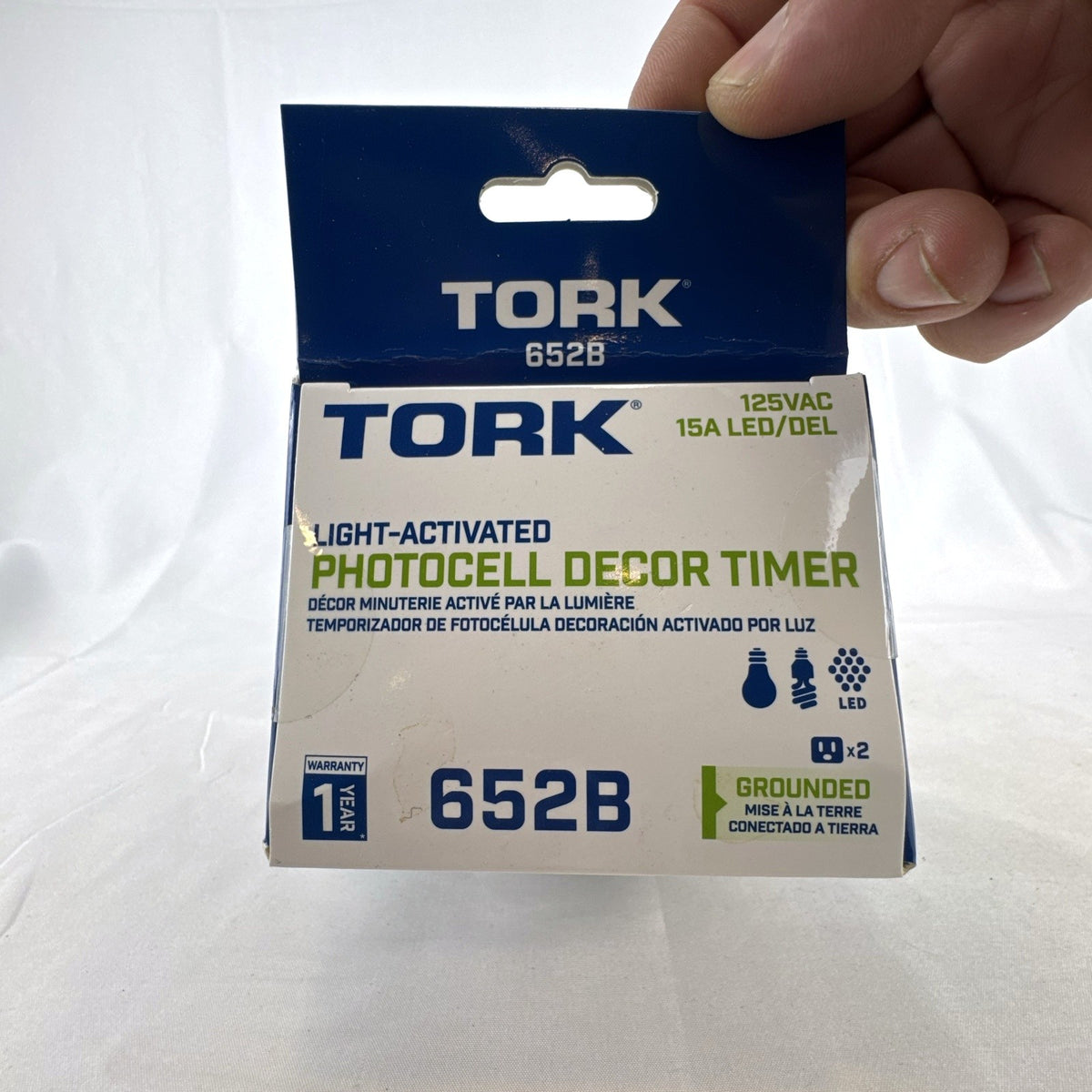 TORK 652B black outdoor photocell light timer with dual grounded outlets in its original packaging.