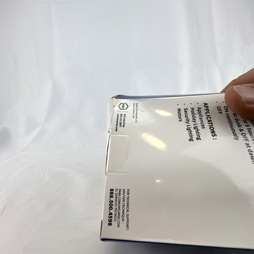 TORK 652B black outdoor photocell light timer with dual grounded outlets in its original packaging.