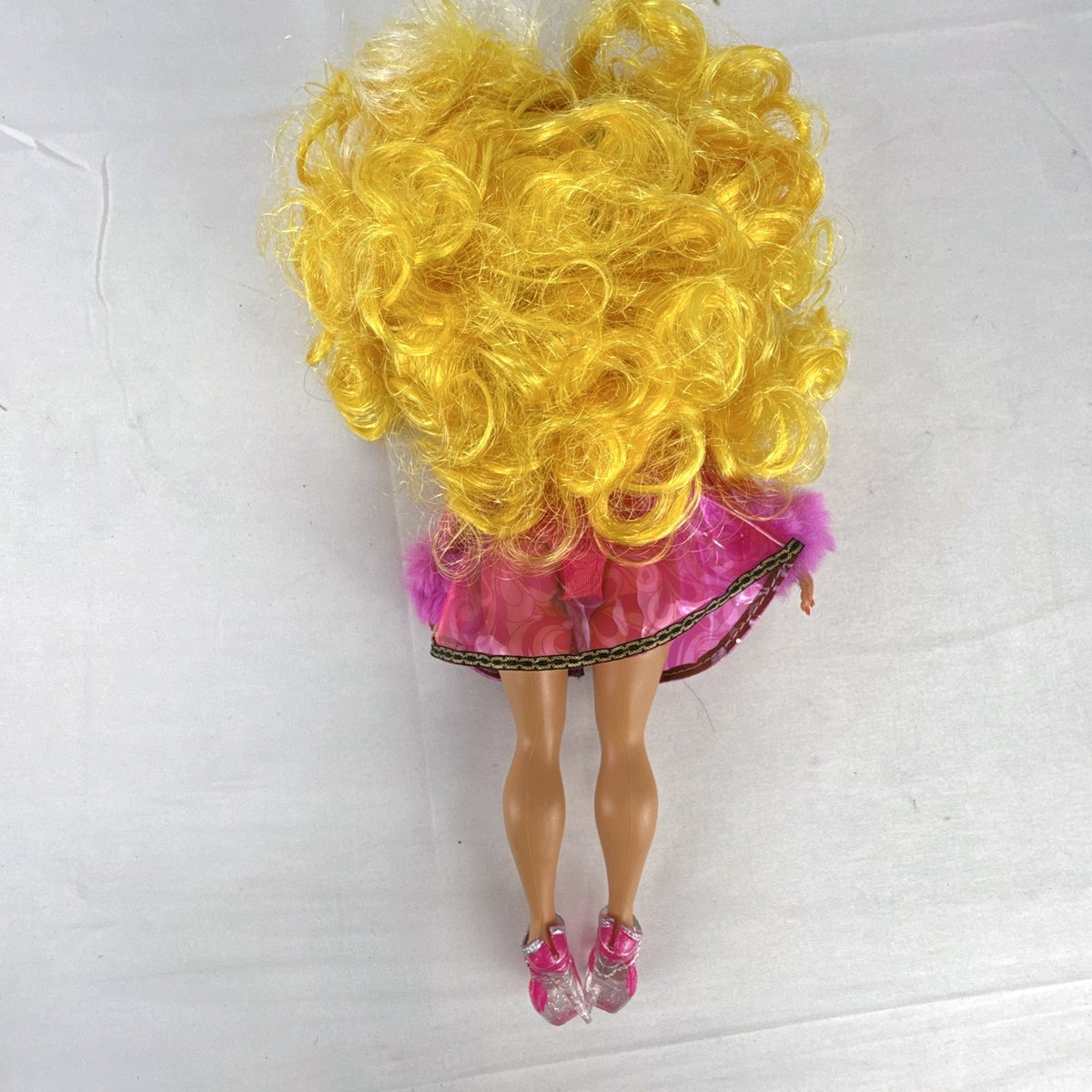MGA L.O.L. Surprise! O.M.G. Da Boss fashion doll in translucent pink faux-fur coat with curly blonde hair