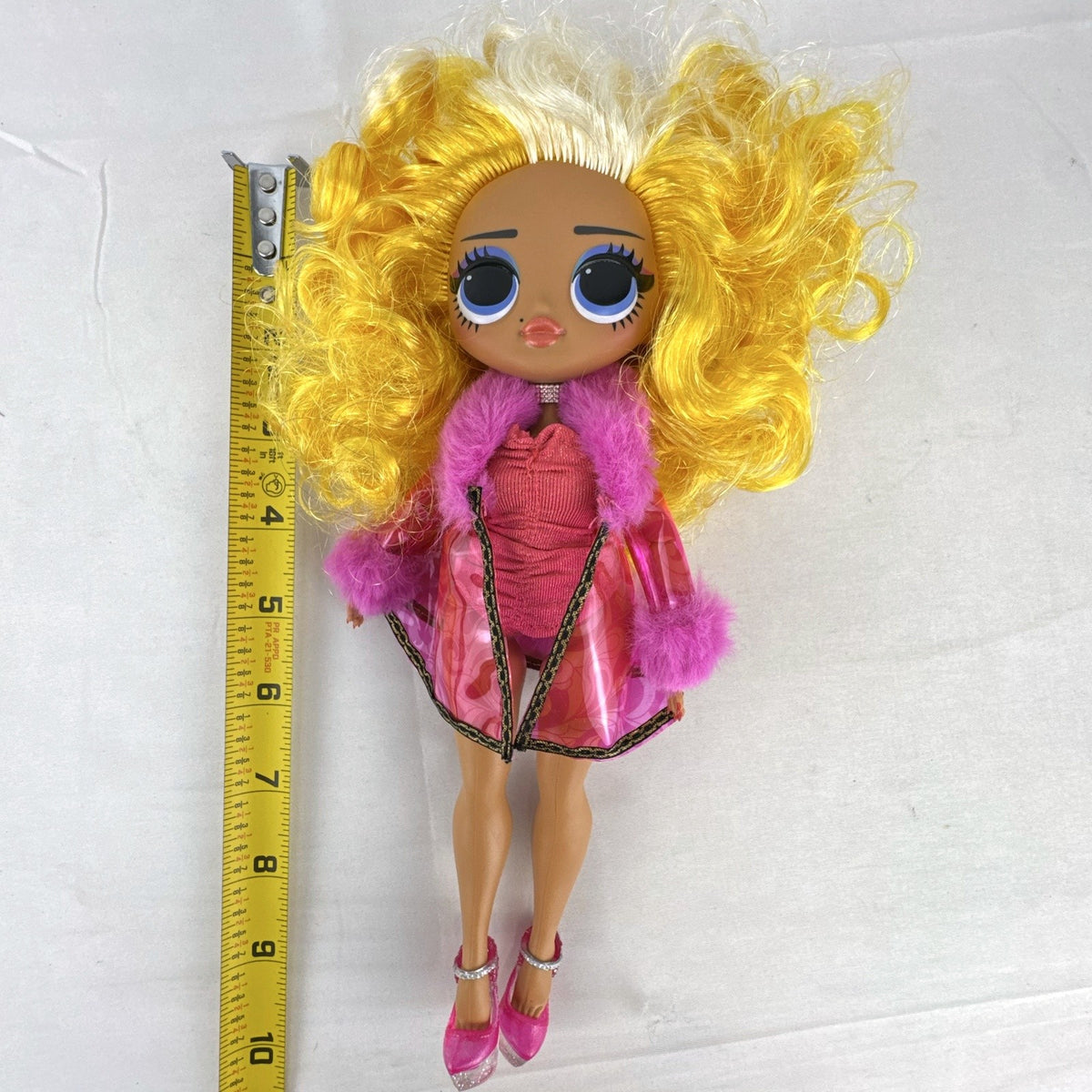 MGA L.O.L. Surprise! O.M.G. Da Boss fashion doll in translucent pink faux-fur coat with curly blonde hair