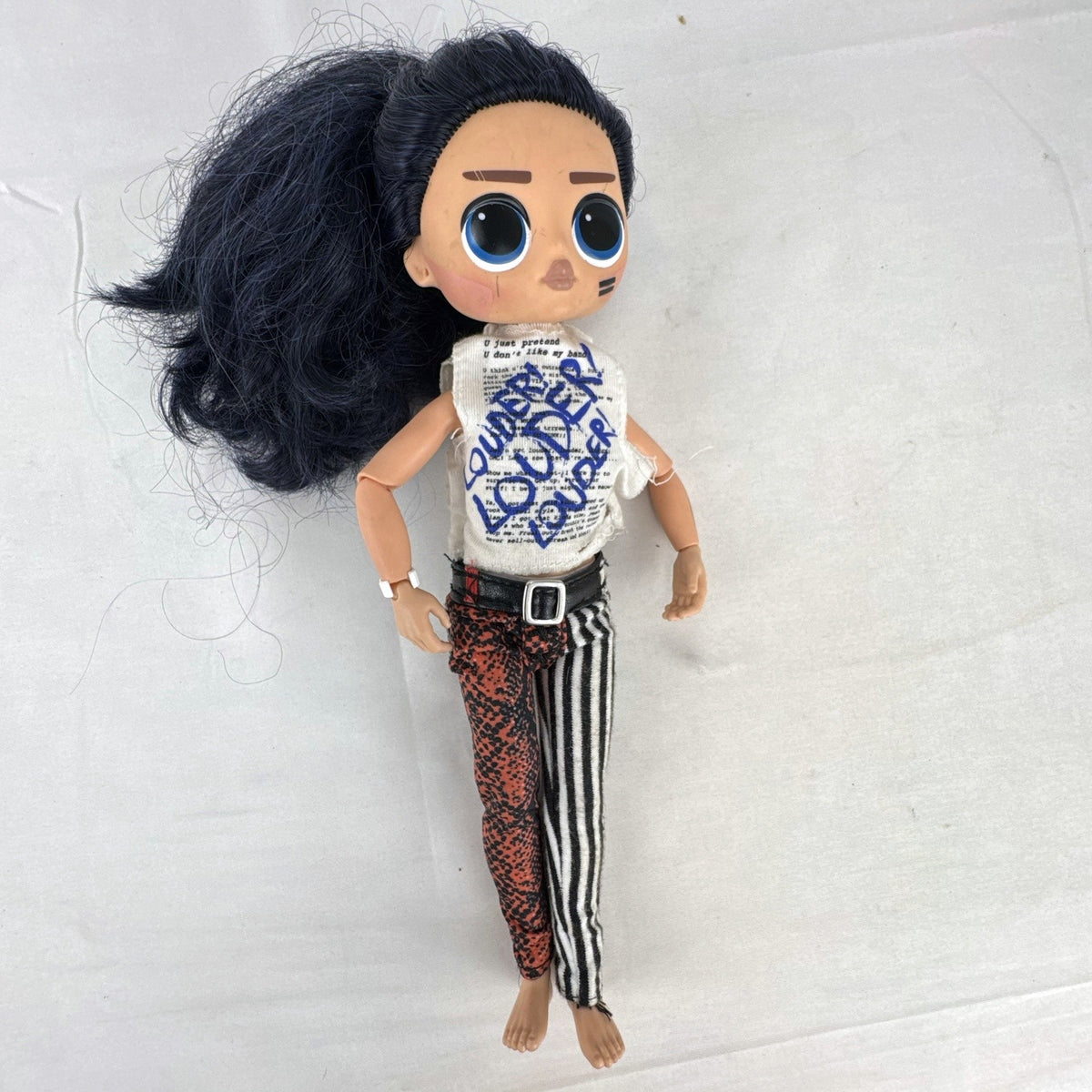 MGA L.O.L. Surprise! O.M.G. Remix Rocker Boi 10-inch articulated male fashion doll in graphic outfit