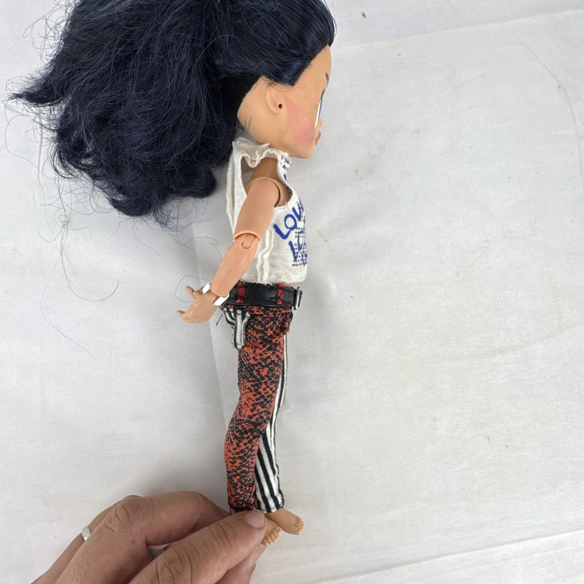 MGA L.O.L. Surprise! O.M.G. Remix Rocker Boi 10-inch articulated male fashion doll in graphic outfit