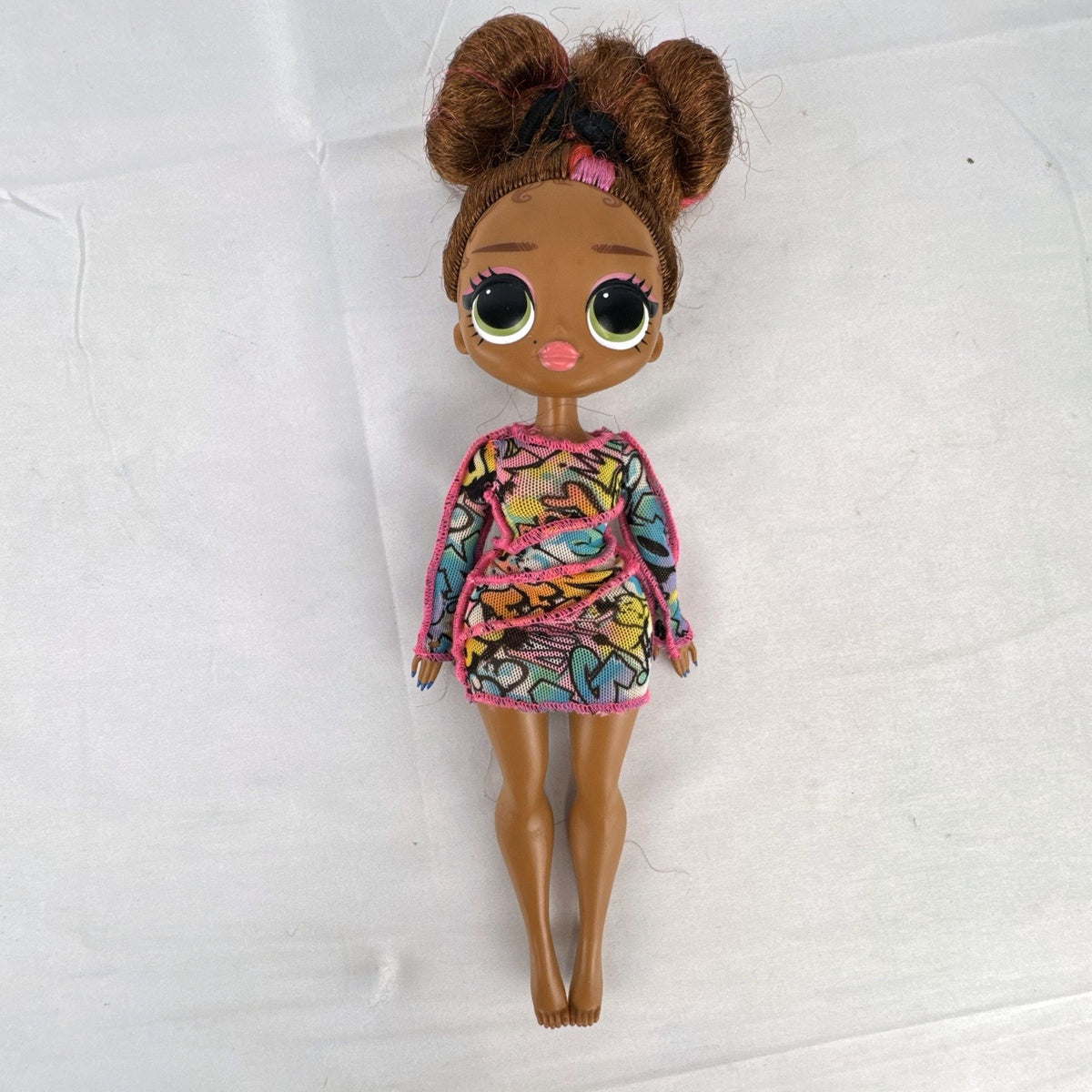 MGA L.O.L. Surprise! O.M.G. 10-inch 24K D.J. Winter Disco fashion doll wearing her graffiti-print dress