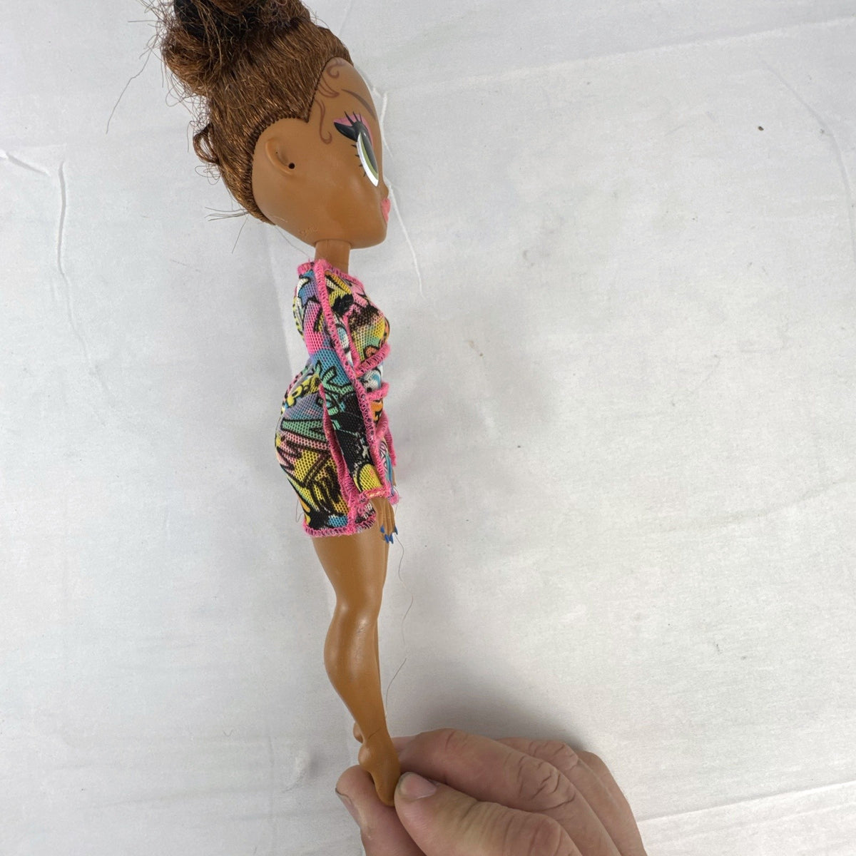 MGA L.O.L. Surprise! O.M.G. 10-inch 24K D.J. Winter Disco fashion doll wearing her graffiti-print dress