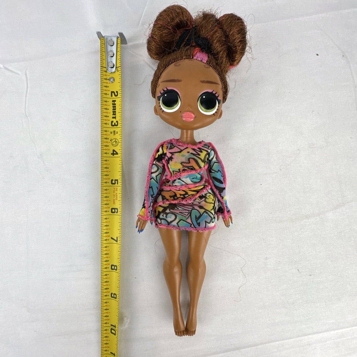 MGA L.O.L. Surprise! O.M.G. 10-inch 24K D.J. Winter Disco fashion doll wearing her graffiti-print dress