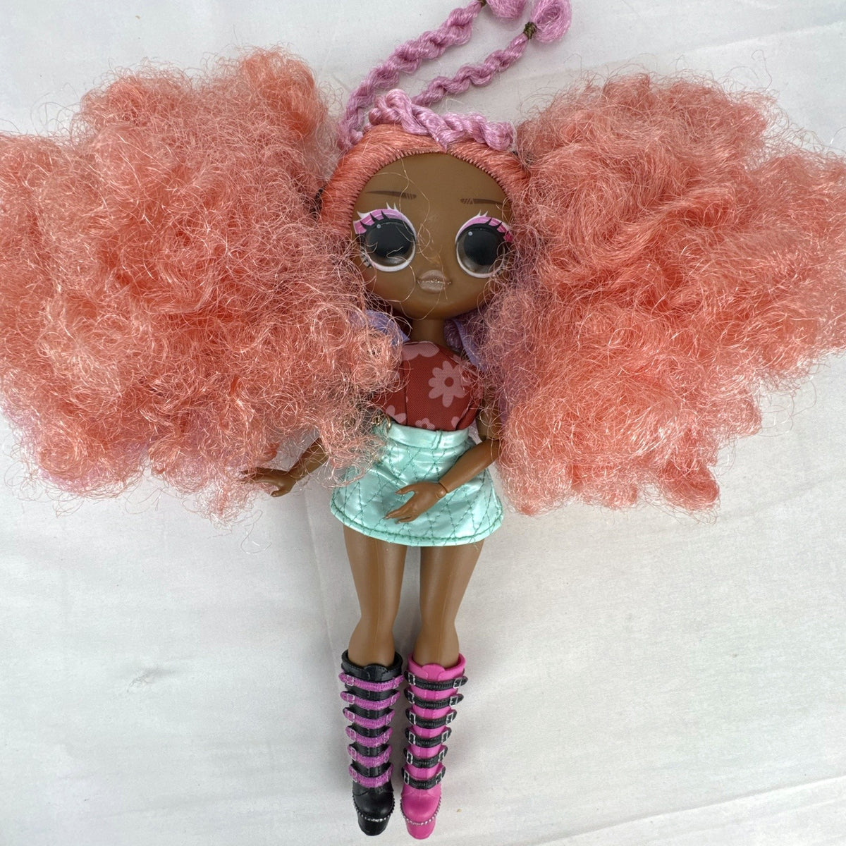 MGA L.O.L. Surprise! O.M.G. Queens Miss Divine 10-inch doll with pink curls, floral top, and metallic skirt
