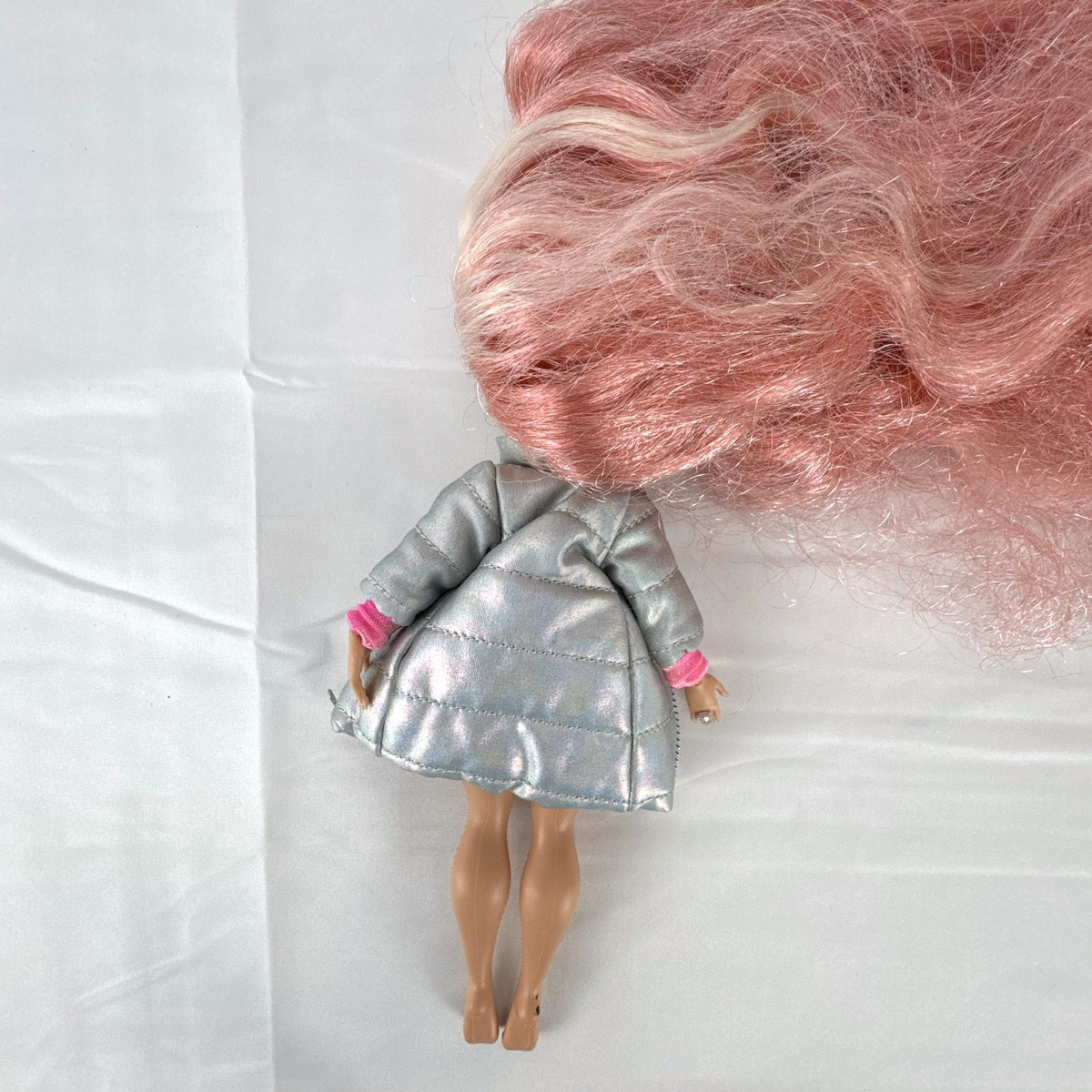 MGA L.O.L. Surprise O.M.G. Cosmic Nova doll in silver puffer jacket with pink crimped hair