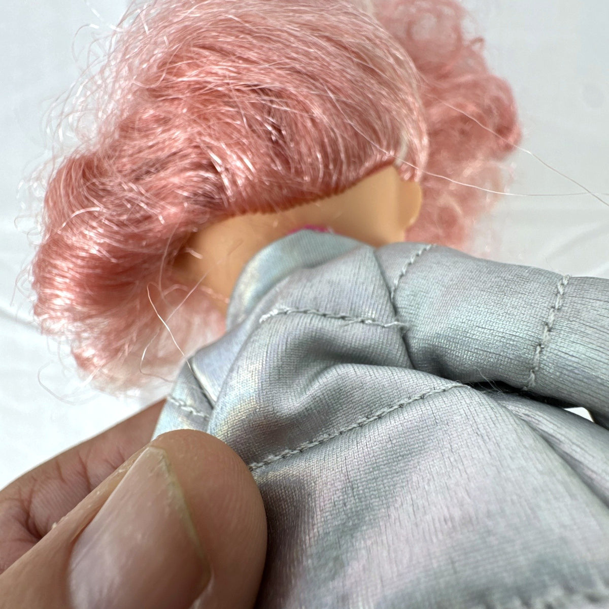 MGA L.O.L. Surprise O.M.G. Cosmic Nova doll in silver puffer jacket with pink crimped hair