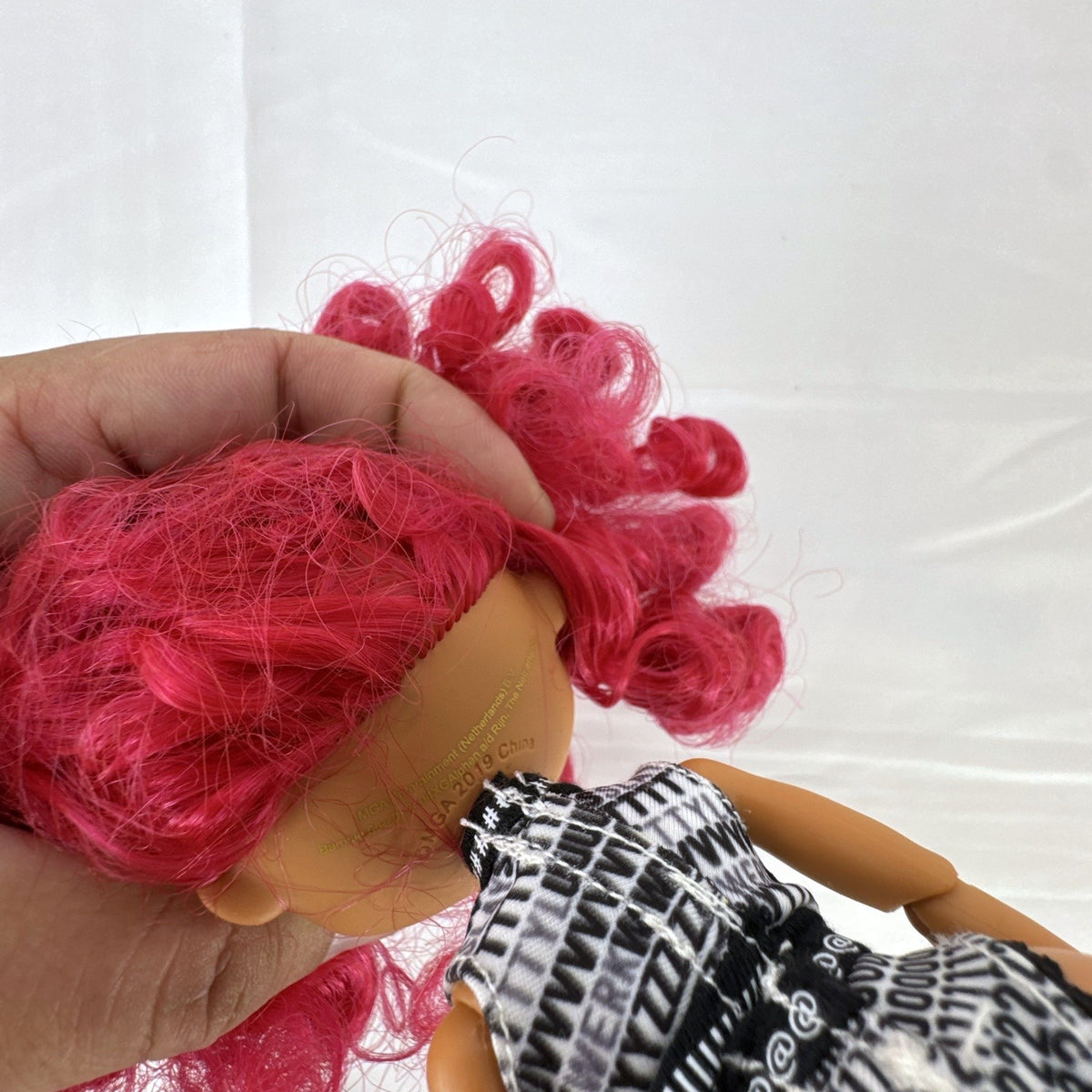 MGA L.O.L. Surprise! O.M.G. Neonlicious 10-inch fashion doll in graphic bodysuit with pink curls