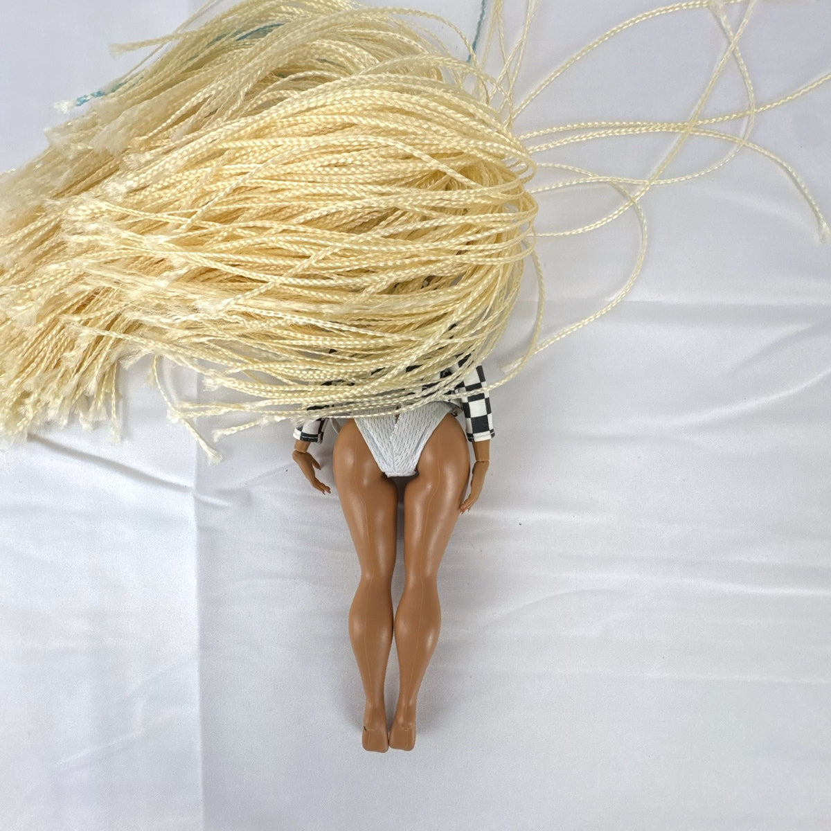 MGA L.O.L. Surprise! O.M.G. Speedster doll in checkerboard racing jacket with blonde micro braids