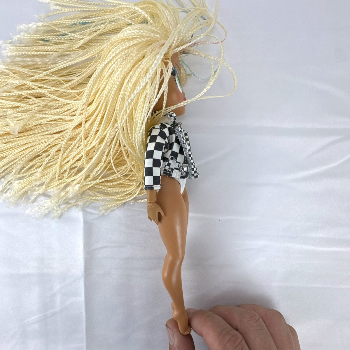 MGA L.O.L. Surprise! O.M.G. Speedster doll in checkerboard racing jacket with blonde micro braids