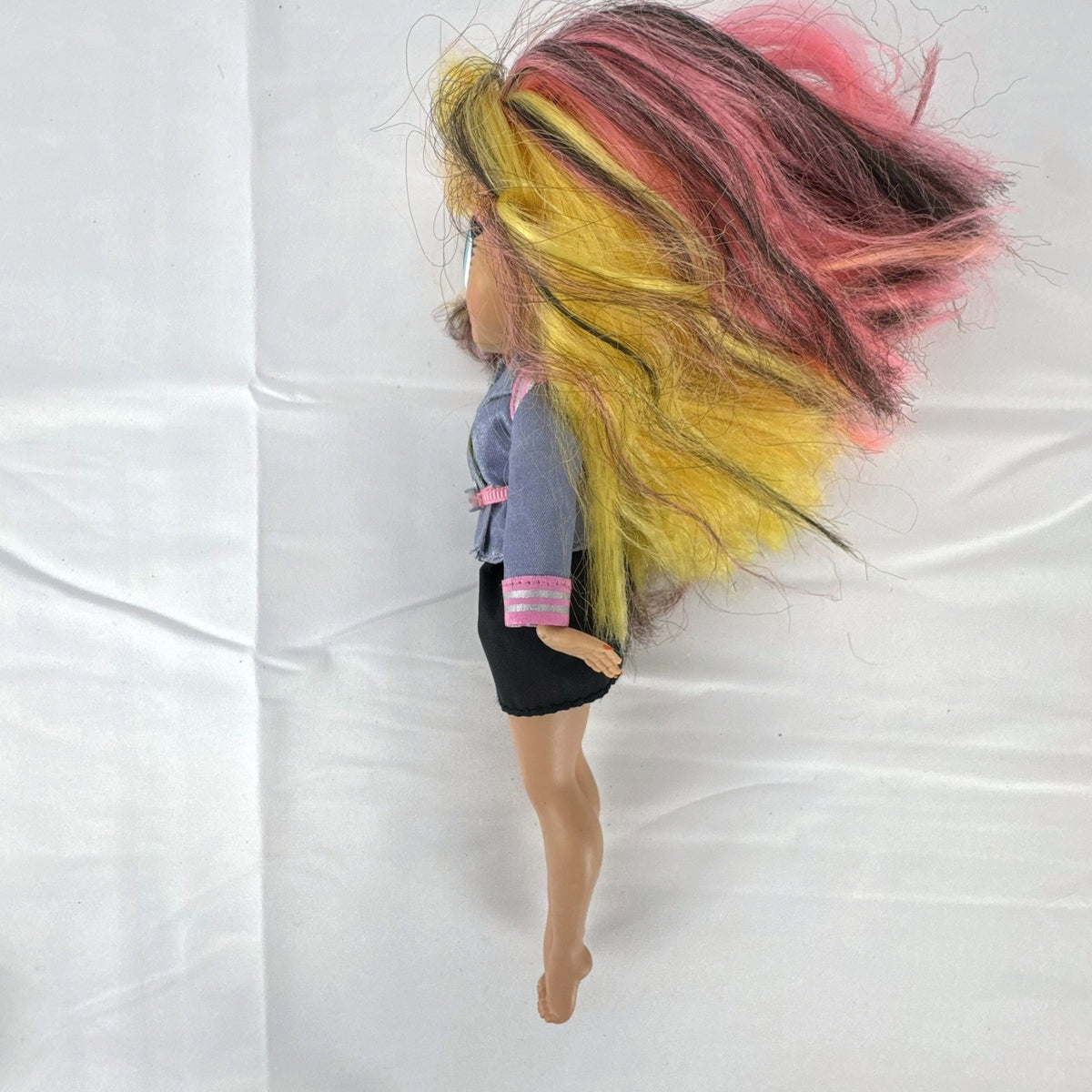 MGA L.O.L. Surprise! O.M.G. Neonlicious 10-inch doll in gray cropped jacket and black shorts.