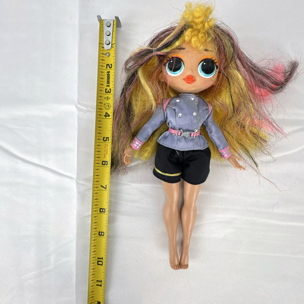 MGA L.O.L. Surprise! O.M.G. Neonlicious 10-inch doll in gray cropped jacket and black shorts.