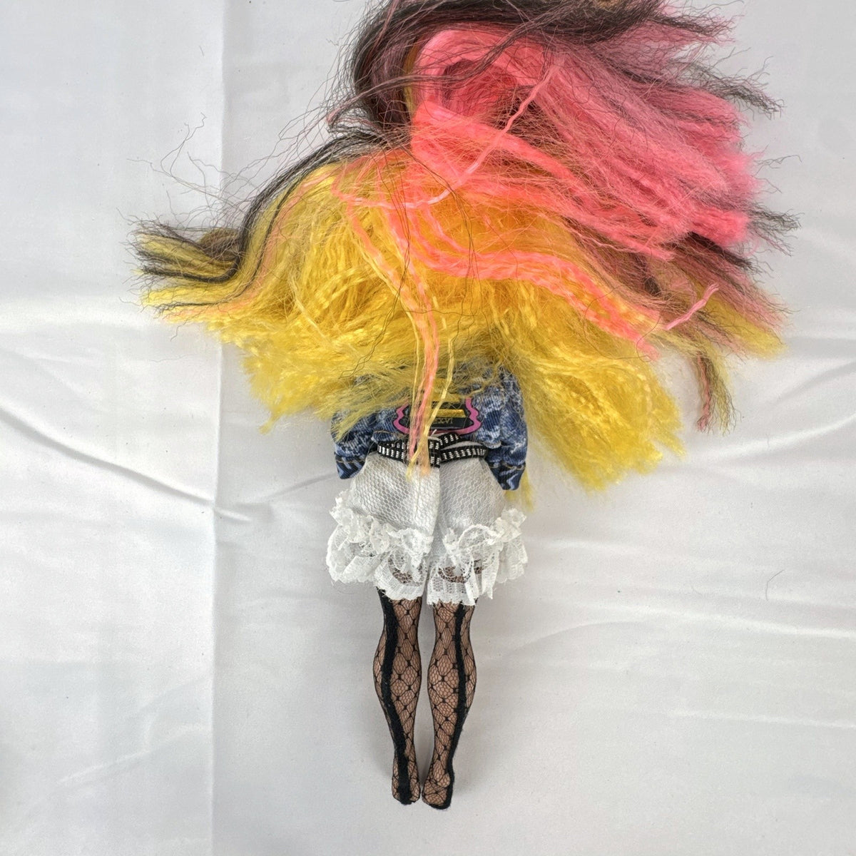 MGA L.O.L. Surprise! O.M.G. Remix Pop B.B. fashion doll wearing acid-wash denim jacket and lace skirt