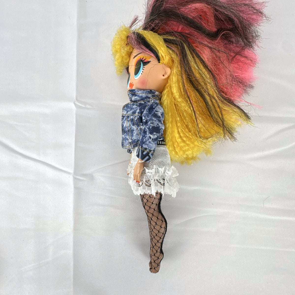 MGA L.O.L. Surprise! O.M.G. Remix Pop B.B. fashion doll wearing acid-wash denim jacket and lace skirt