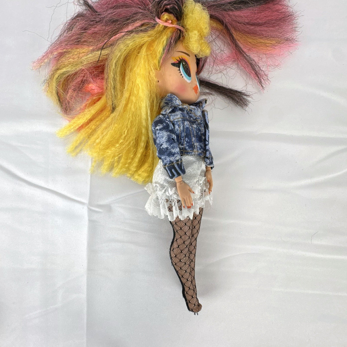 MGA L.O.L. Surprise! O.M.G. Remix Pop B.B. fashion doll wearing acid-wash denim jacket and lace skirt