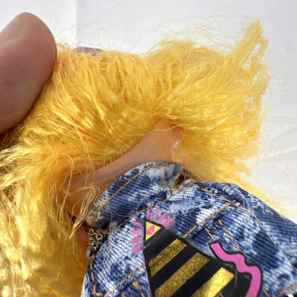 MGA L.O.L. Surprise! O.M.G. Remix Pop B.B. fashion doll wearing acid-wash denim jacket and lace skirt