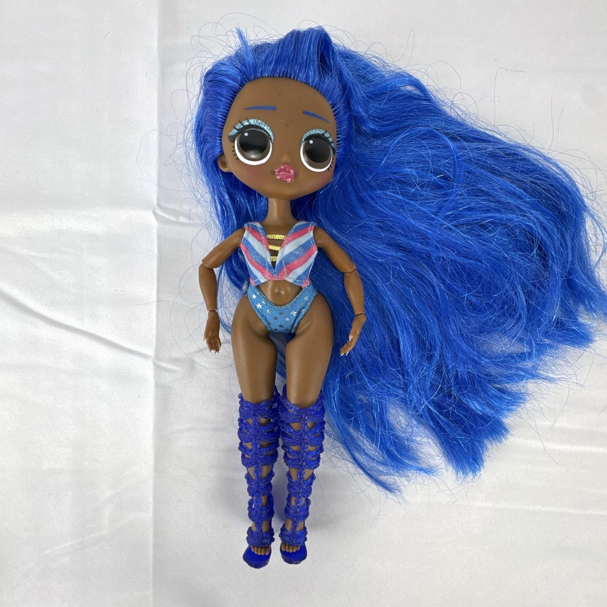 MGA LOL Surprise OMG Miss Independent fashion doll with long blue hair, swimsuit, and gladiator boots