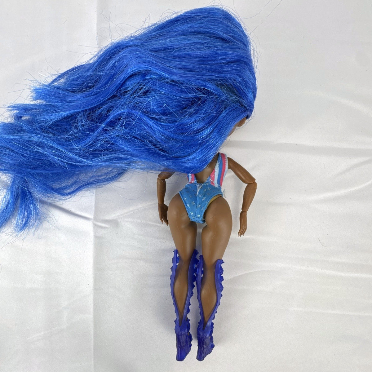 MGA LOL Surprise OMG Miss Independent fashion doll with long blue hair, swimsuit, and gladiator boots