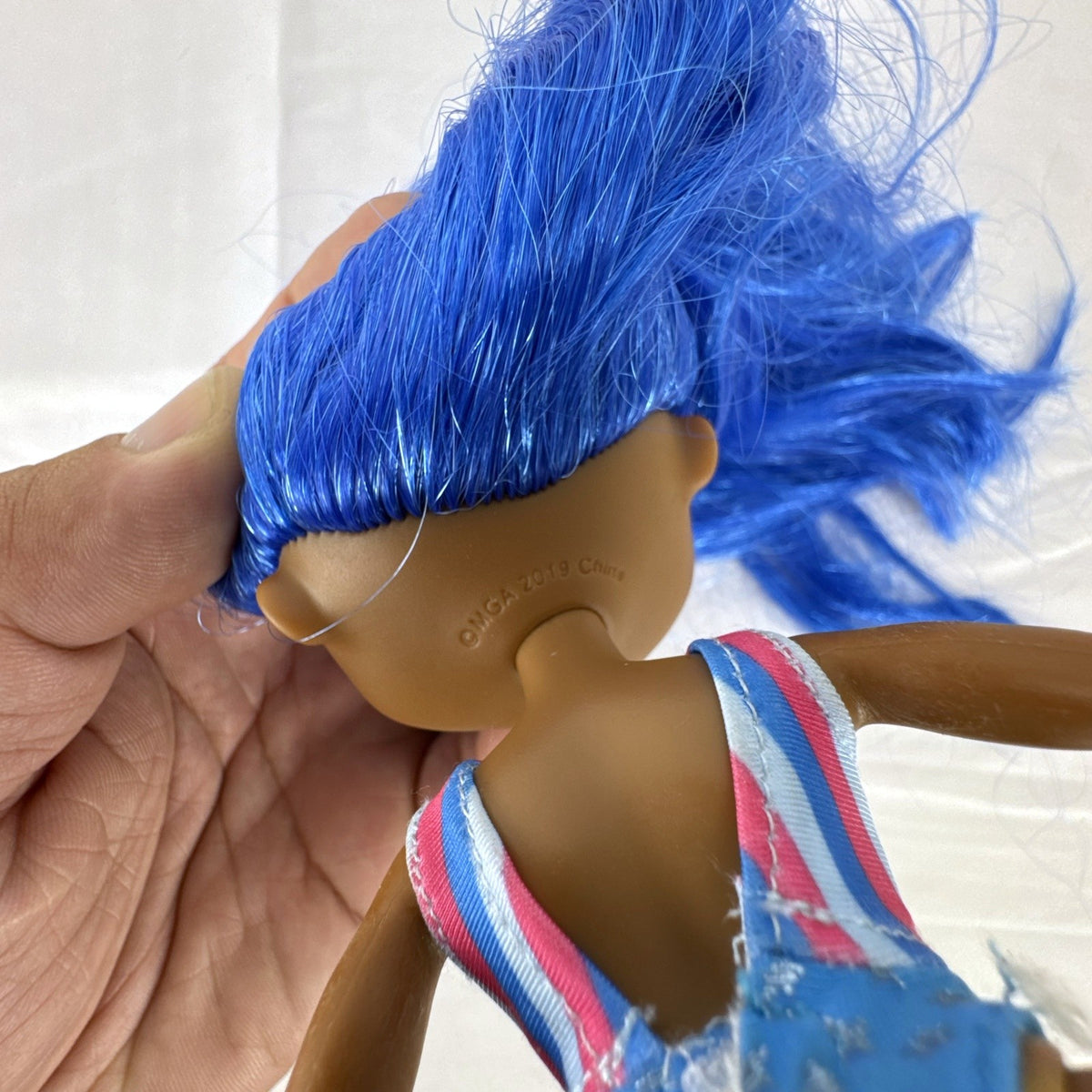 MGA LOL Surprise OMG Miss Independent fashion doll with long blue hair, swimsuit, and gladiator boots