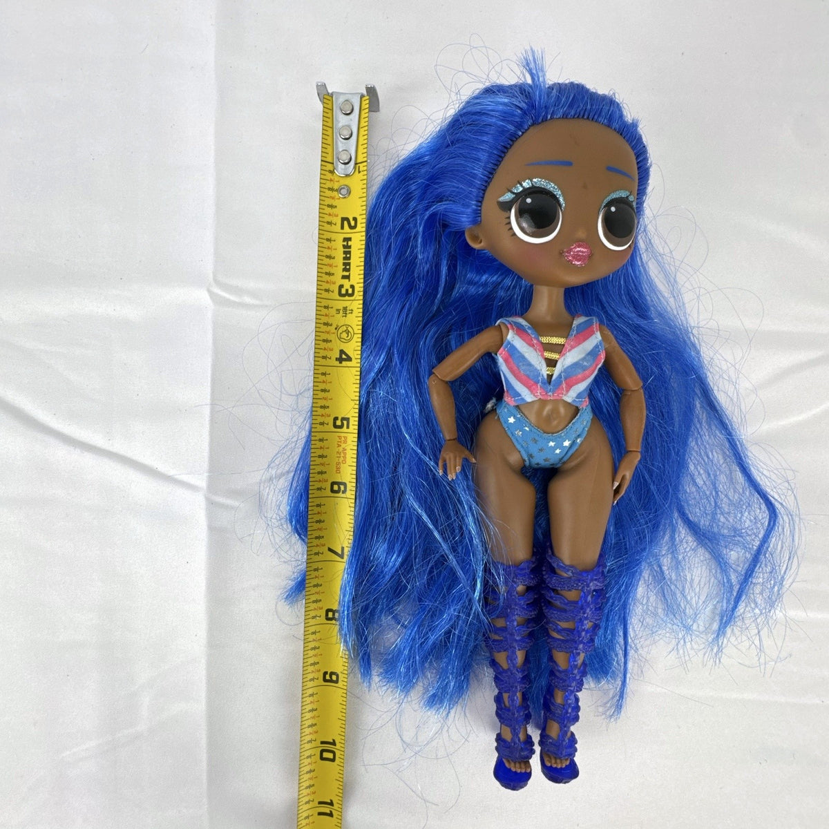 MGA LOL Surprise OMG Miss Independent fashion doll with long blue hair, swimsuit, and gladiator boots