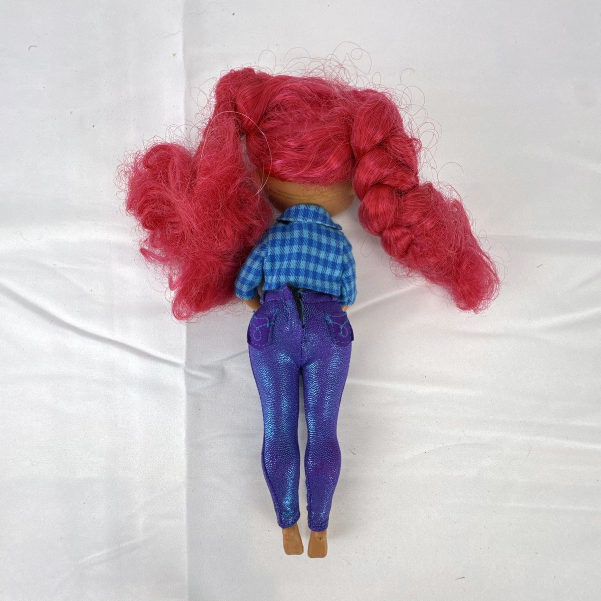 MGA L.O.L. Surprise! O.M.G. Downtown B.B. 10-inch doll with pink curly hair in blue plaid jacket and purple pants