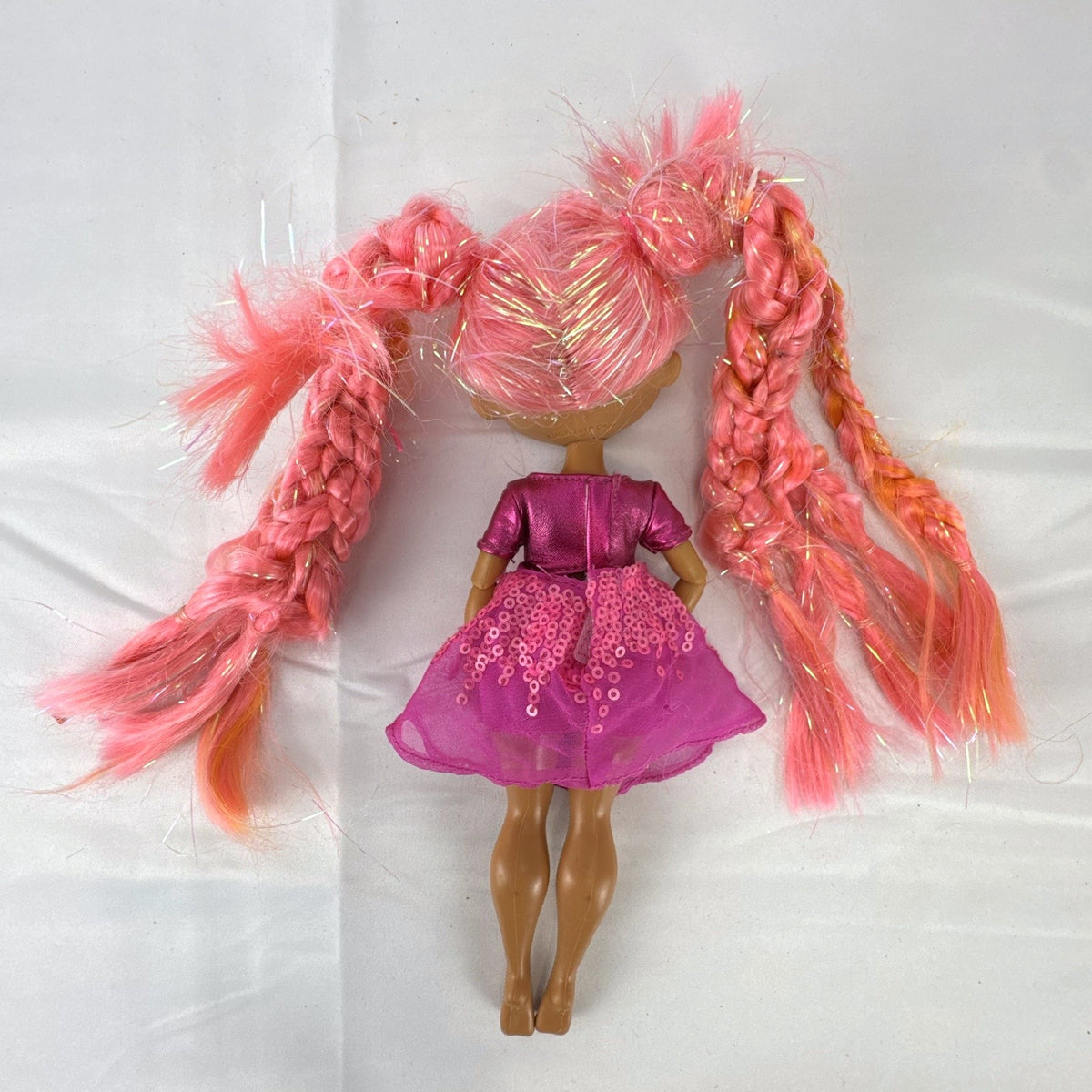MGA L.O.L. Surprise O.M.G. Lights Dazzle 10-inch fashion doll with braided pink tinsel hair in a metallic sequin dress