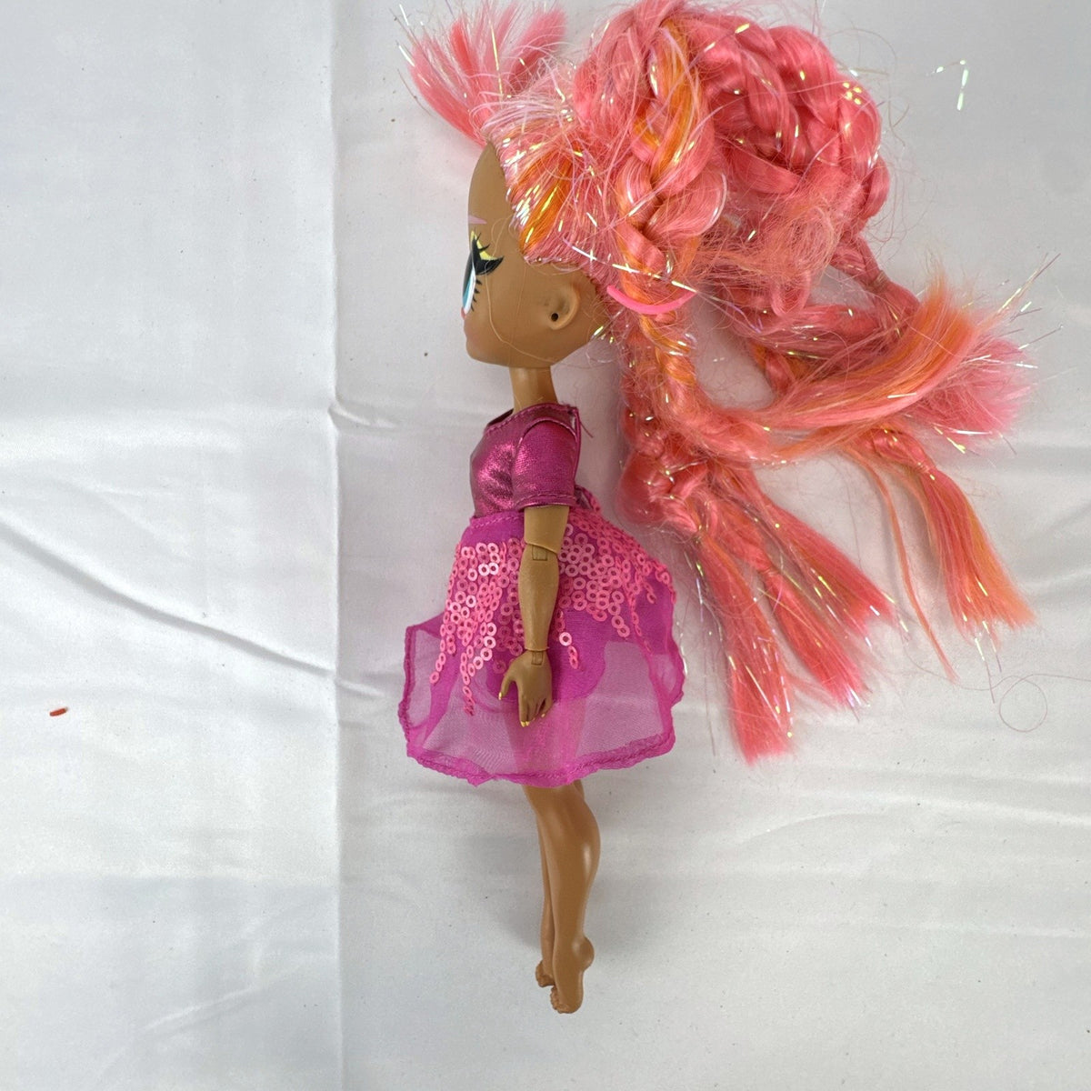 MGA L.O.L. Surprise O.M.G. Lights Dazzle 10-inch fashion doll with braided pink tinsel hair in a metallic sequin dress