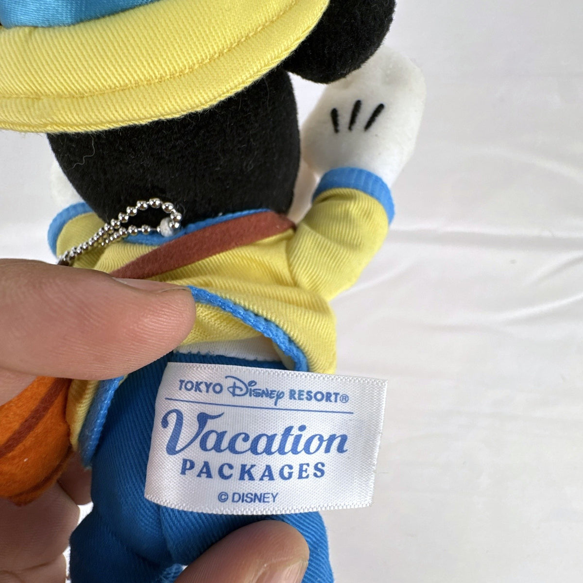 Tokyo Disney Resort Vacation Packages Mickey Mouse 9.5 inch plush keychain with hand clips in yellow travel outfit