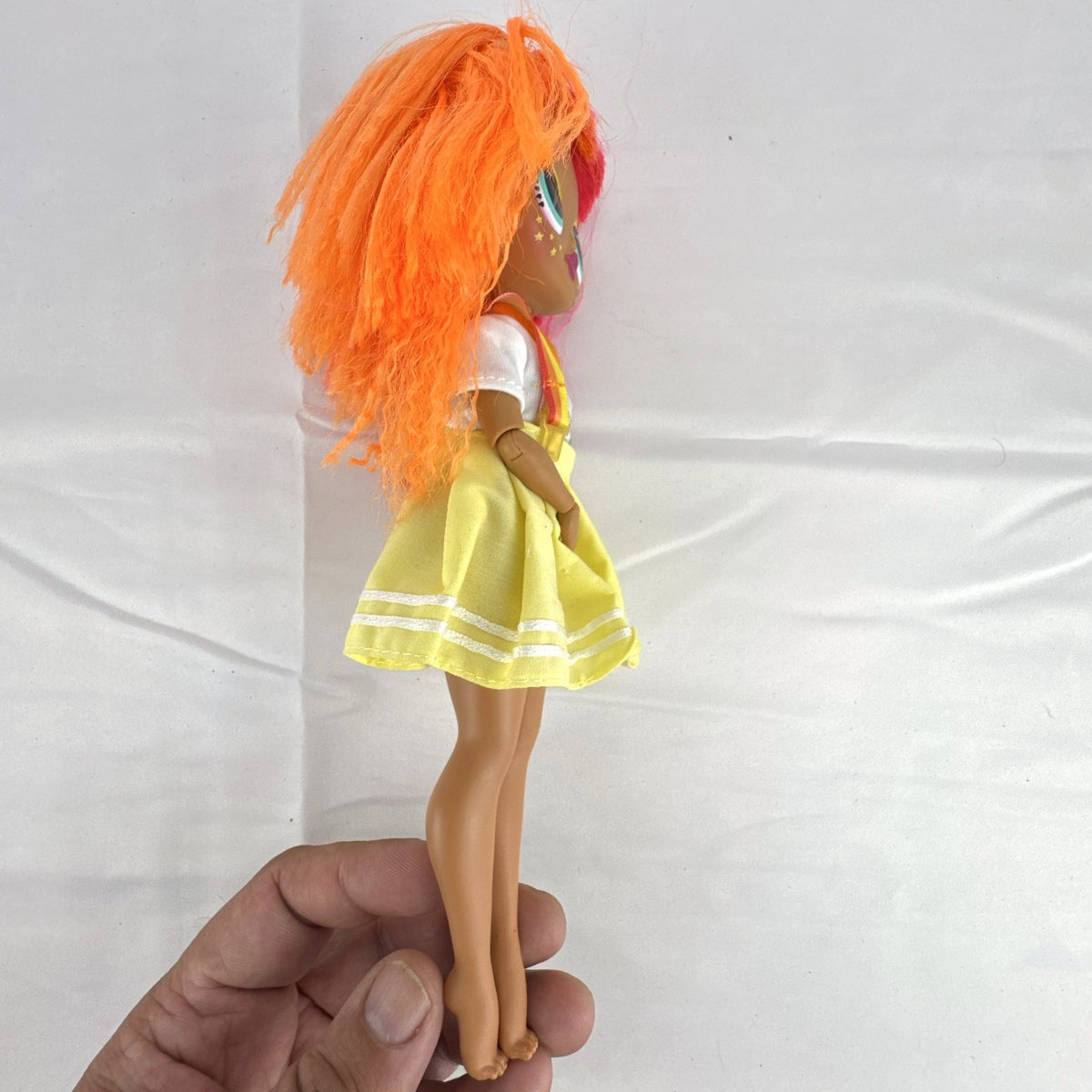 MGA LOL Surprise OMG Neonlicious fashion doll with split neon orange and pink hair and pleated skirt