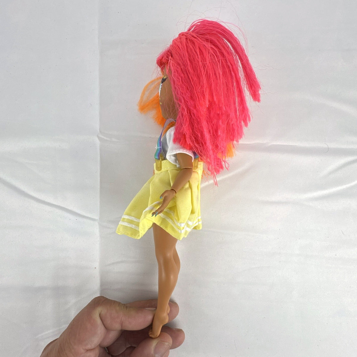 MGA LOL Surprise OMG Neonlicious fashion doll with split neon orange and pink hair and pleated skirt