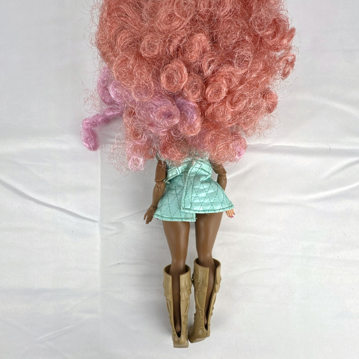 MGA L.O.L. Surprise! O.M.G. Roller Chick fashion doll with voluminous pink curls wearing a mint outfit and tall boots.