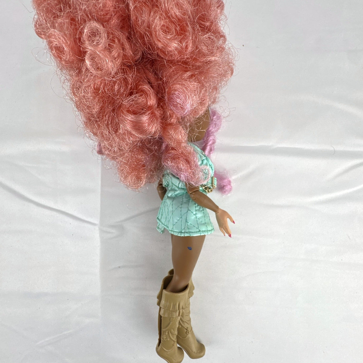 MGA L.O.L. Surprise! O.M.G. Roller Chick fashion doll with voluminous pink curls wearing a mint outfit and tall boots.