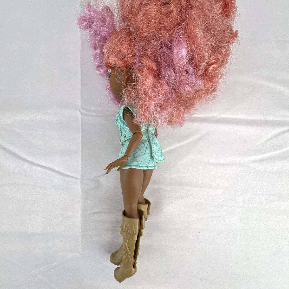 MGA L.O.L. Surprise! O.M.G. Roller Chick fashion doll with voluminous pink curls wearing a mint outfit and tall boots.