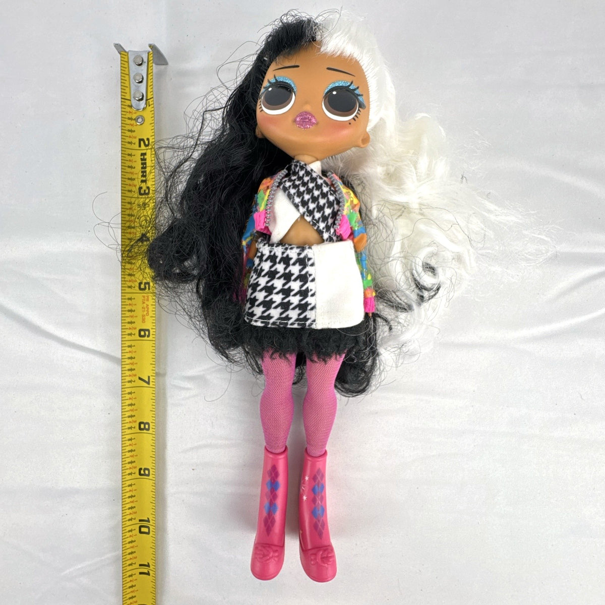 MGA L.O.L. Surprise! O.M.G. 10-inch fashion doll with split black and white curly hair in houndstooth outfit
