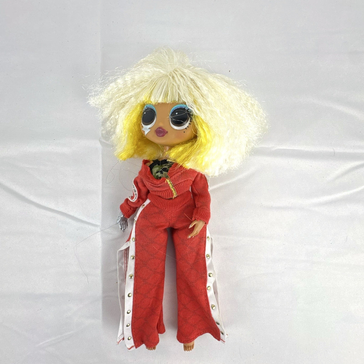 MGA L.O.L. Surprise! O.M.G. Lights Speedster 10-inch fashion doll wearing red tracksuit with blonde and neon yellow hair