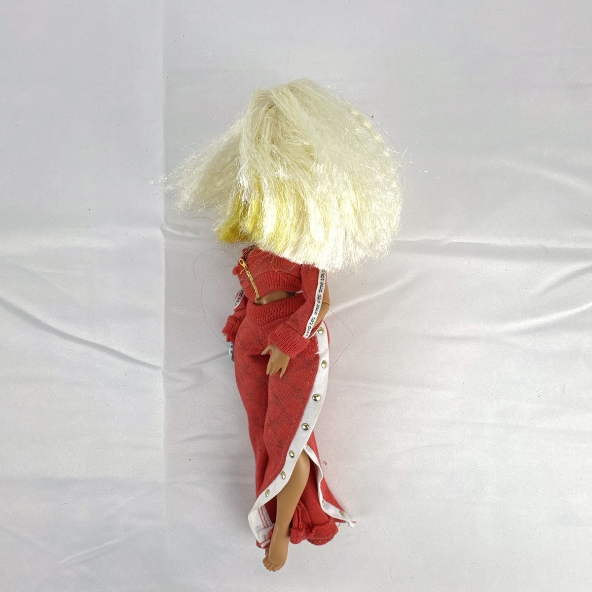 MGA L.O.L. Surprise! O.M.G. Lights Speedster 10-inch fashion doll wearing red tracksuit with blonde and neon yellow hair