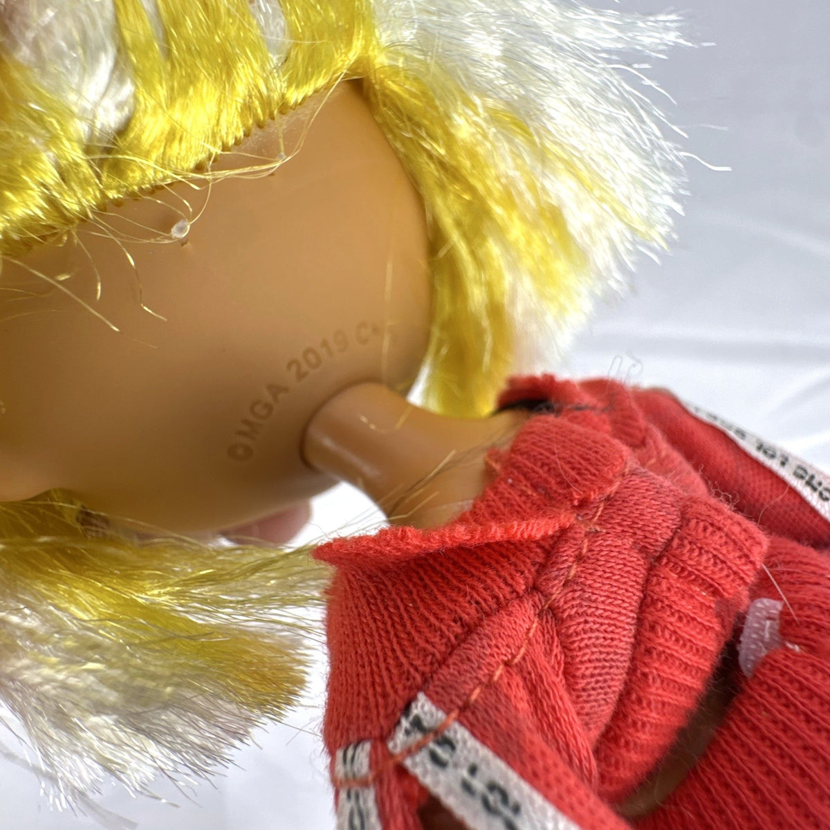 MGA L.O.L. Surprise! O.M.G. Lights Speedster 10-inch fashion doll wearing red tracksuit with blonde and neon yellow hair