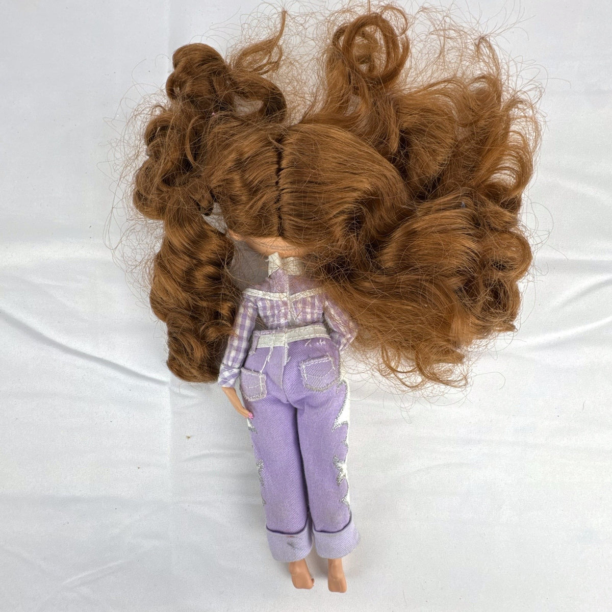 MGA L.O.L. Surprise! O.M.G. Remix Lonestar fashion doll wearing a purple western cowgirl outfit