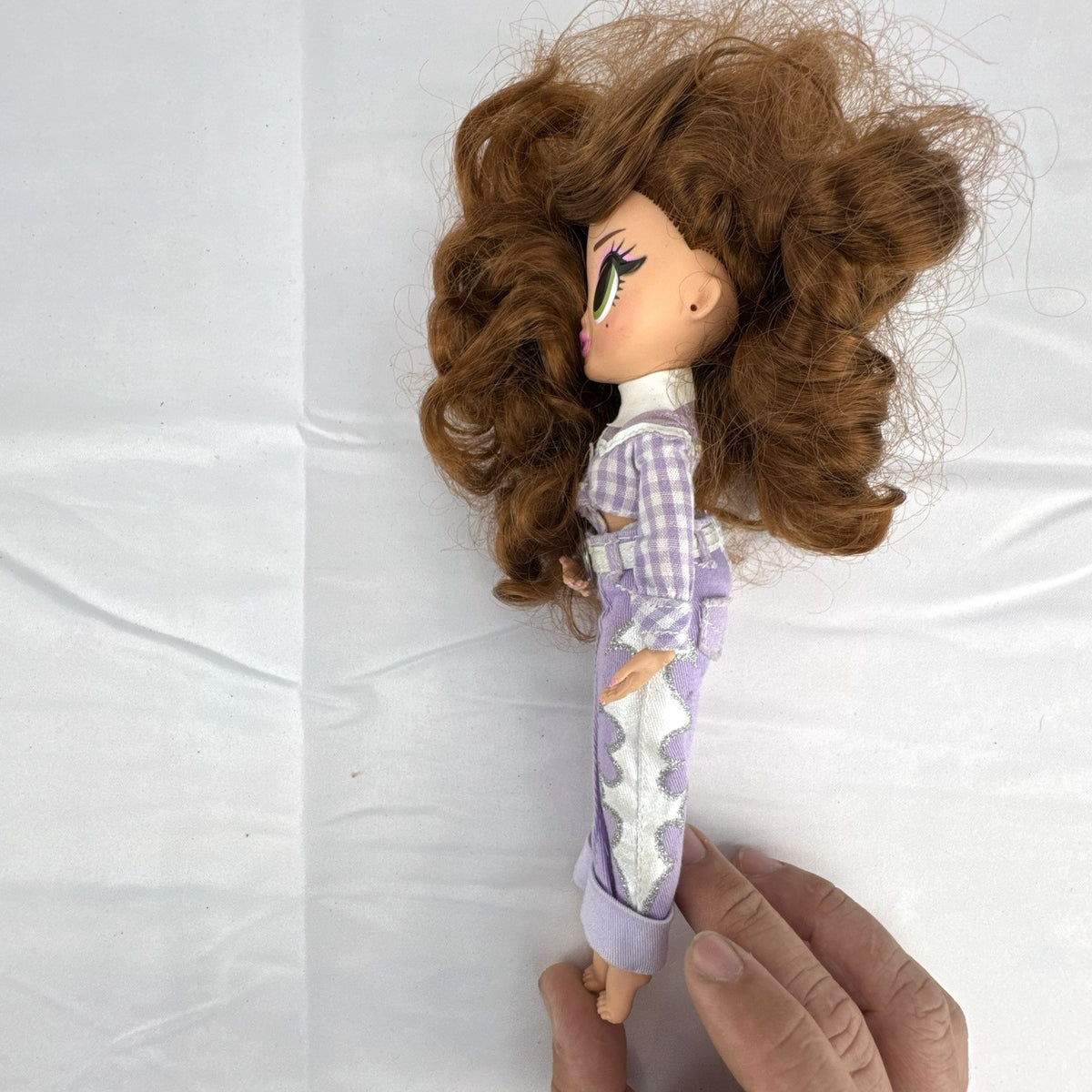 MGA L.O.L. Surprise! O.M.G. Remix Lonestar fashion doll wearing a purple western cowgirl outfit
