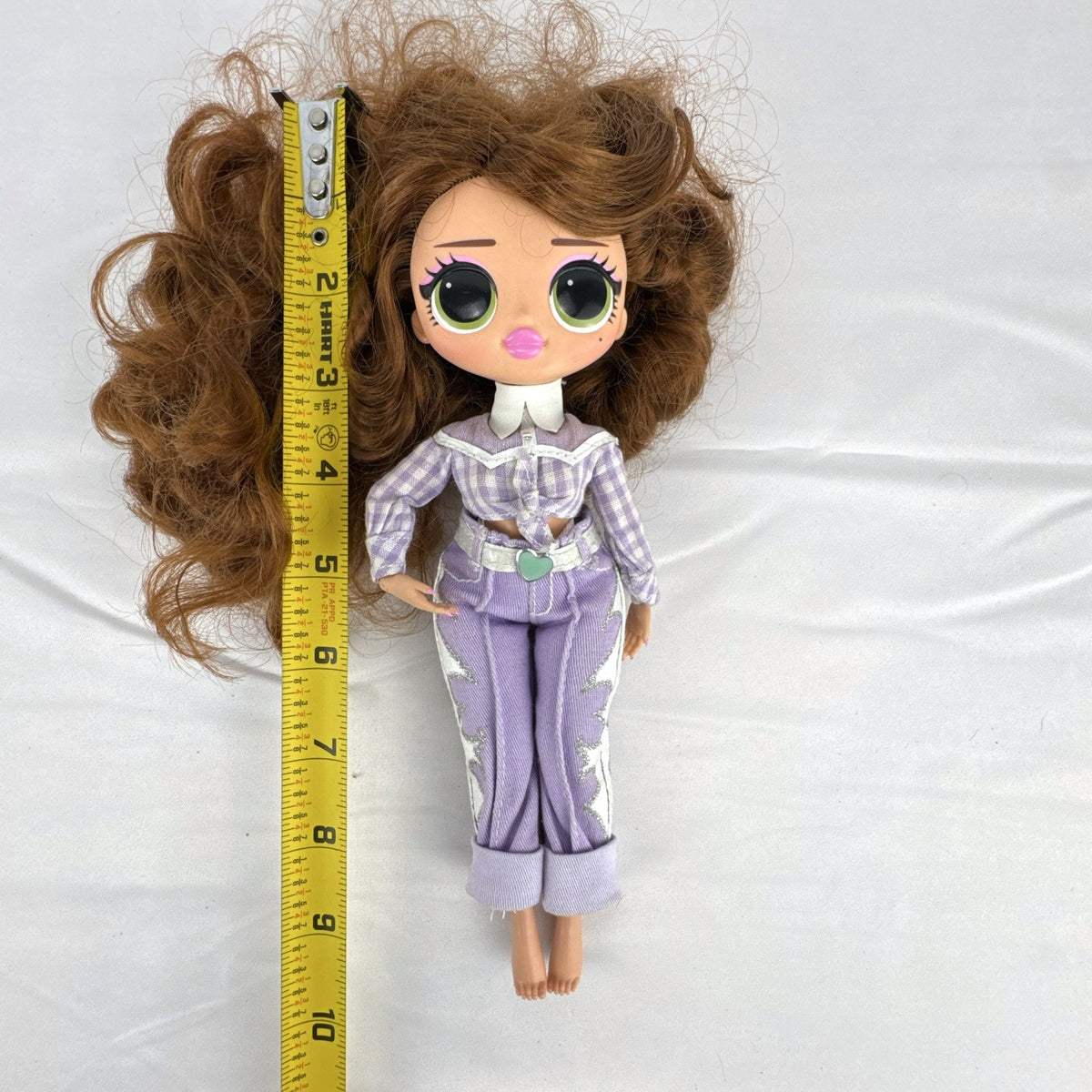 MGA L.O.L. Surprise! O.M.G. Remix Lonestar fashion doll wearing a purple western cowgirl outfit