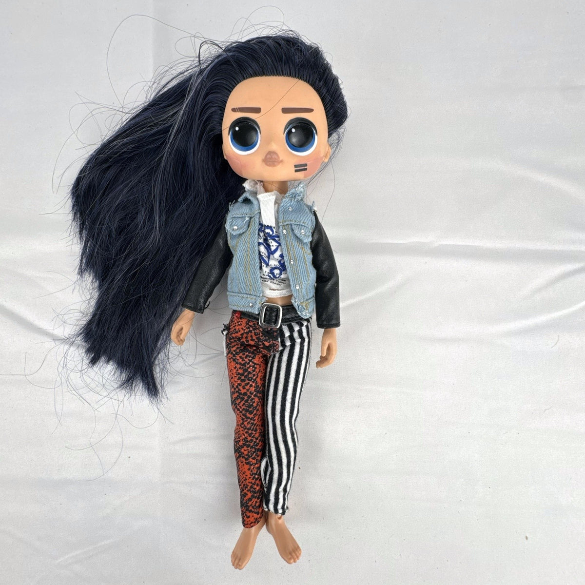 MGA L.O.L. Surprise! O.M.G. Remix Rocker Boi 10-inch articulated fashion doll in graphic tee, jacket, and pants