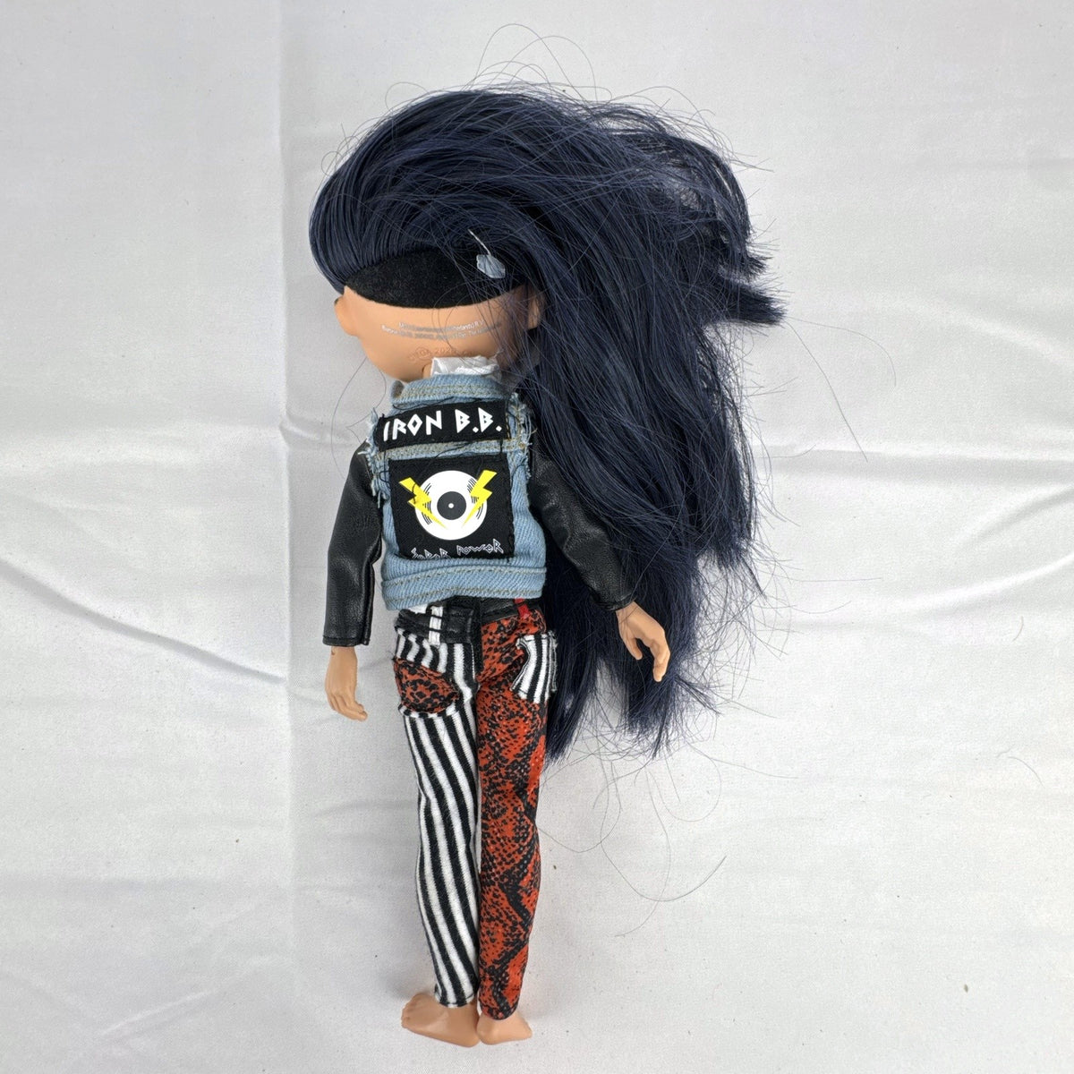 MGA L.O.L. Surprise! O.M.G. Remix Rocker Boi 10-inch articulated fashion doll in graphic tee, jacket, and pants