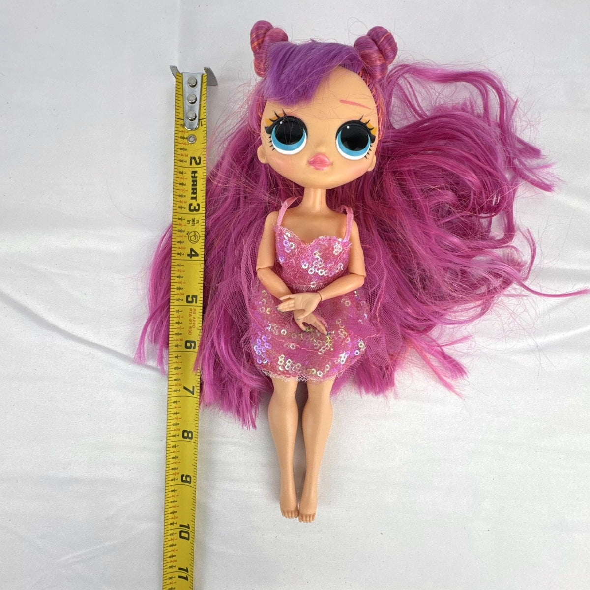 MGA Entertainment L.O.L. Surprise O.M.G. Lights Dazzle 10-inch fashion doll with pink hair in a sparkly sequin dress.