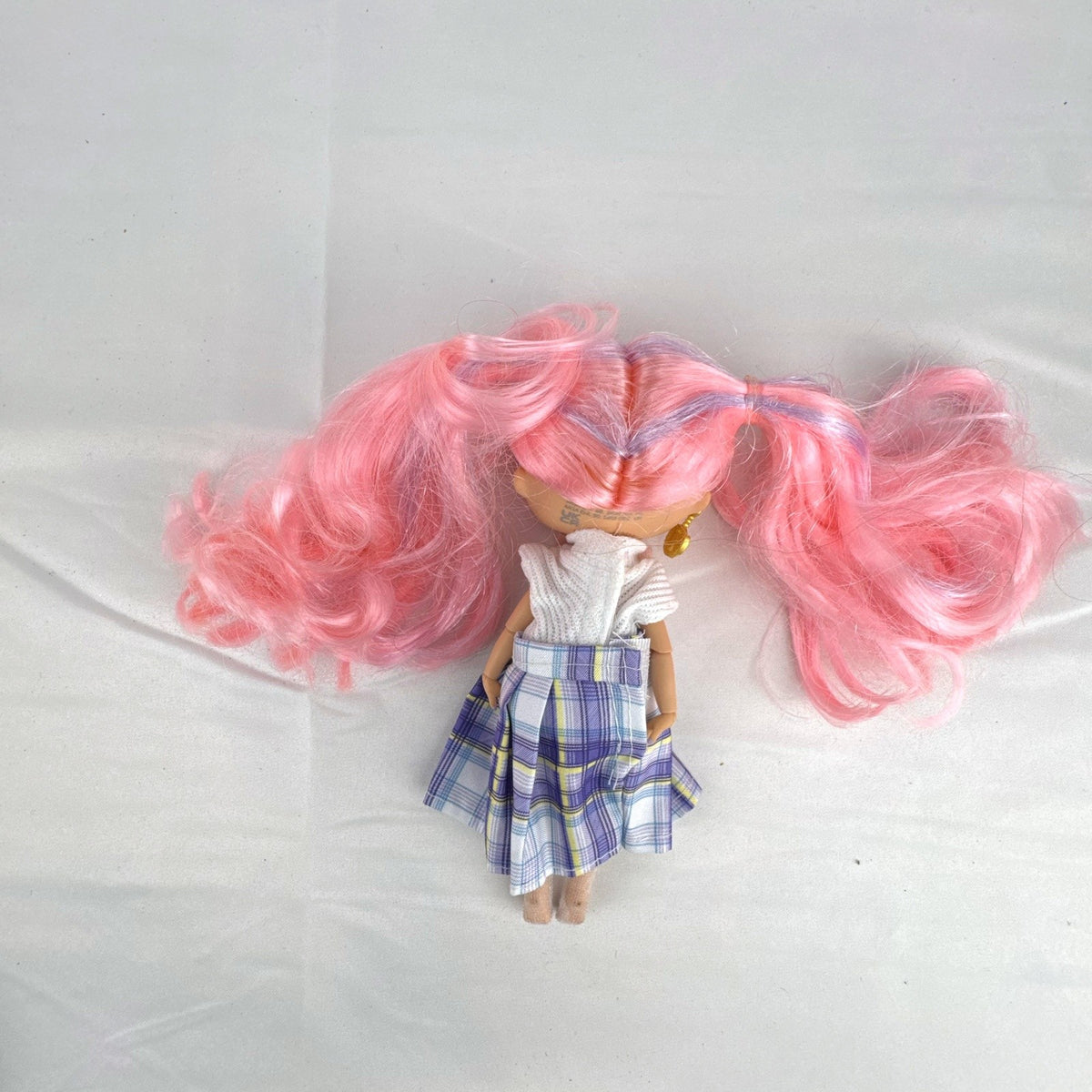 MGA L.O.L. Surprise O.M.G. Tweens Fancy Gurl fashion doll in purple plaid skirt with pink pigtails