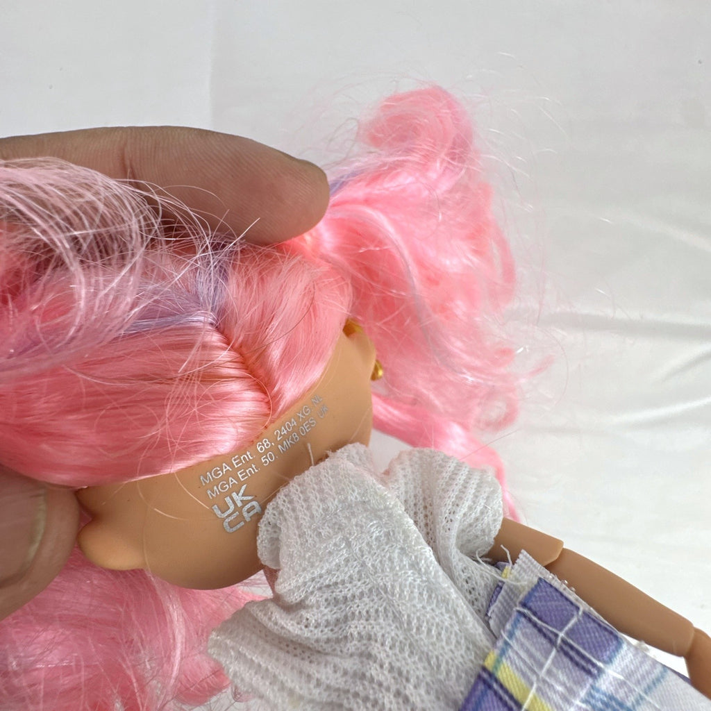 MGA L.O.L. Surprise O.M.G. Tweens Fancy Gurl fashion doll in purple plaid skirt with pink pigtails