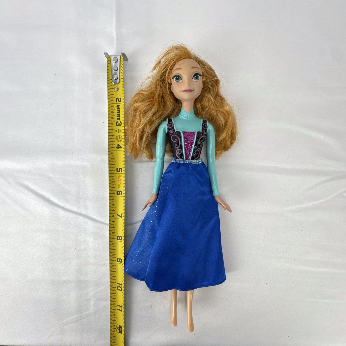 Hasbro Disney Frozen Royal Shimmer Anna 11-inch fashion doll with molded bodice and blue glitter skirt