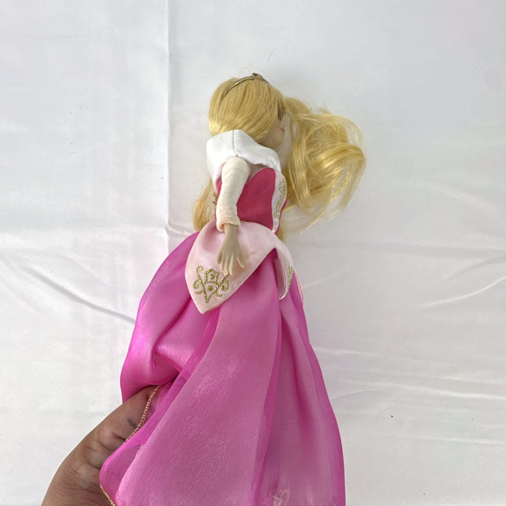 The Brass Key Disney Princess Aurora 12-inch porcelain doll wearing a pink ballgown and golden tiara