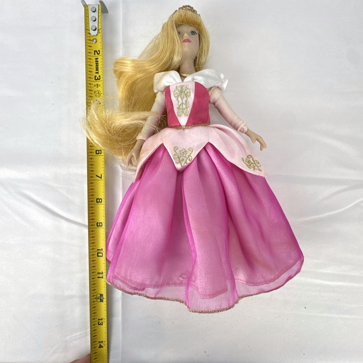 The Brass Key Disney Princess Aurora 12-inch porcelain doll wearing a pink ballgown and golden tiara